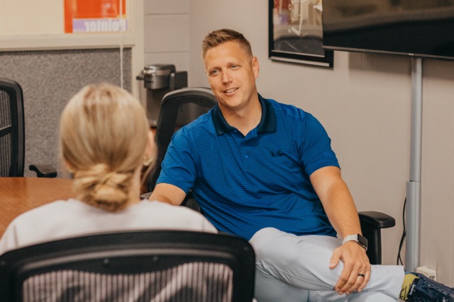Principal sitting down with student.